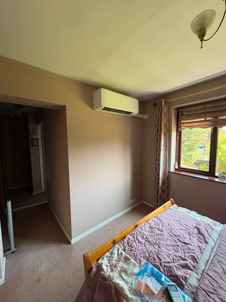 Wall-mounted air conditioning unit installed in a bedroom as part of a Stourbridge multi-split system