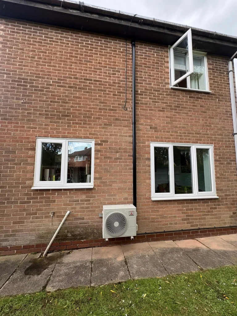 Mitsubishi air conditioning outdoor condenser unit installed at a home in Warwick